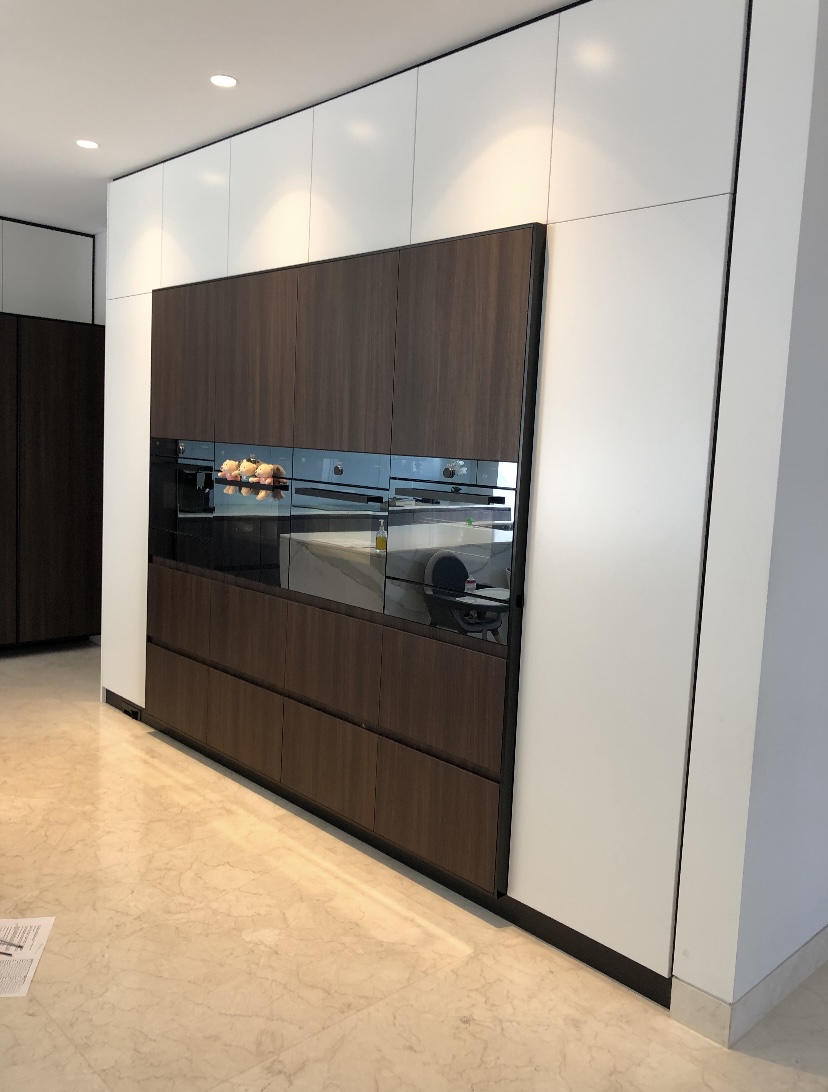 Floor-to-ceiling kitchen joinery with timber appliance bank and white handleless cabinetry by Mr Woodworx