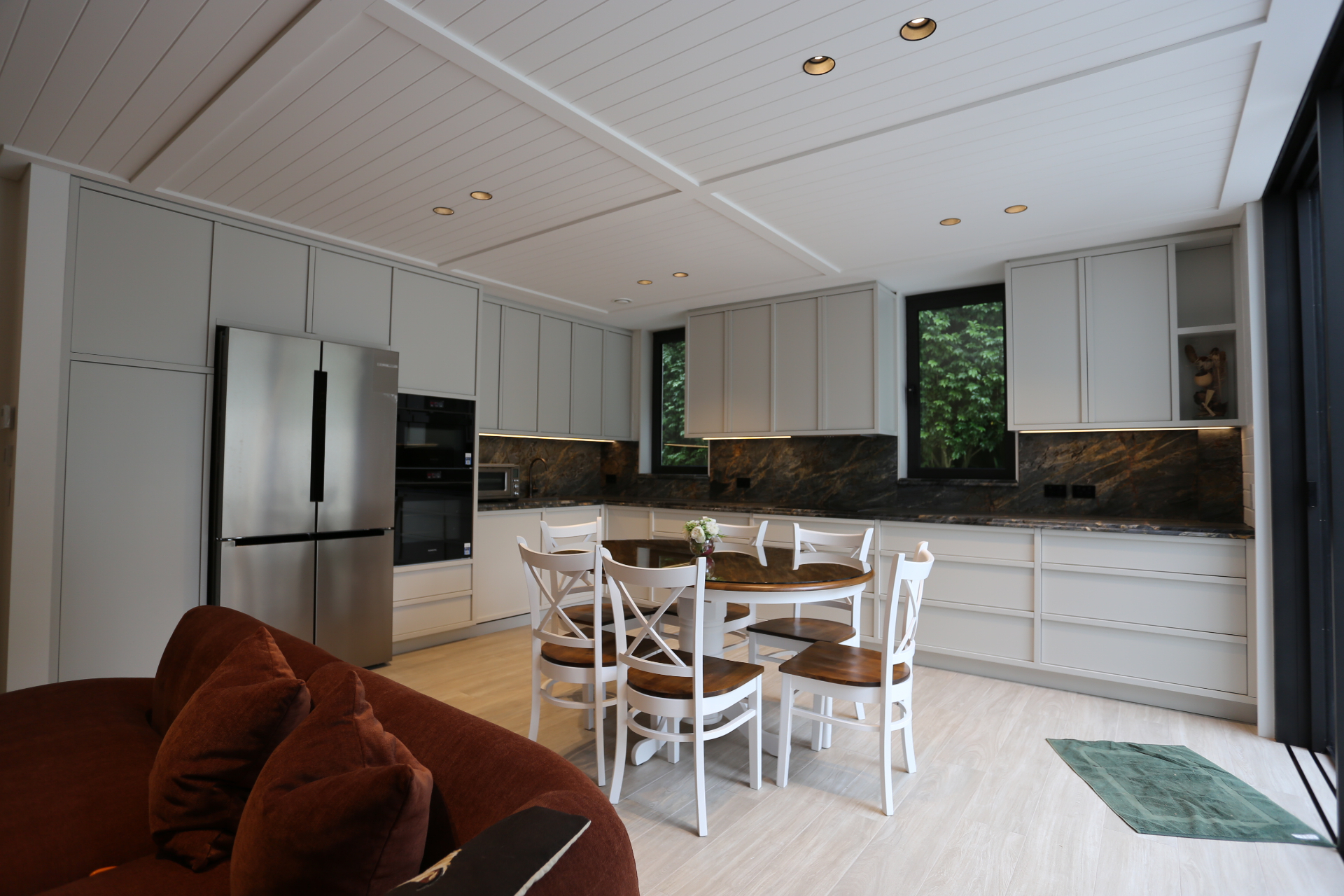 Soft grey shaker kitchen with stone splashback and panelled ceiling by Mr Woodworx