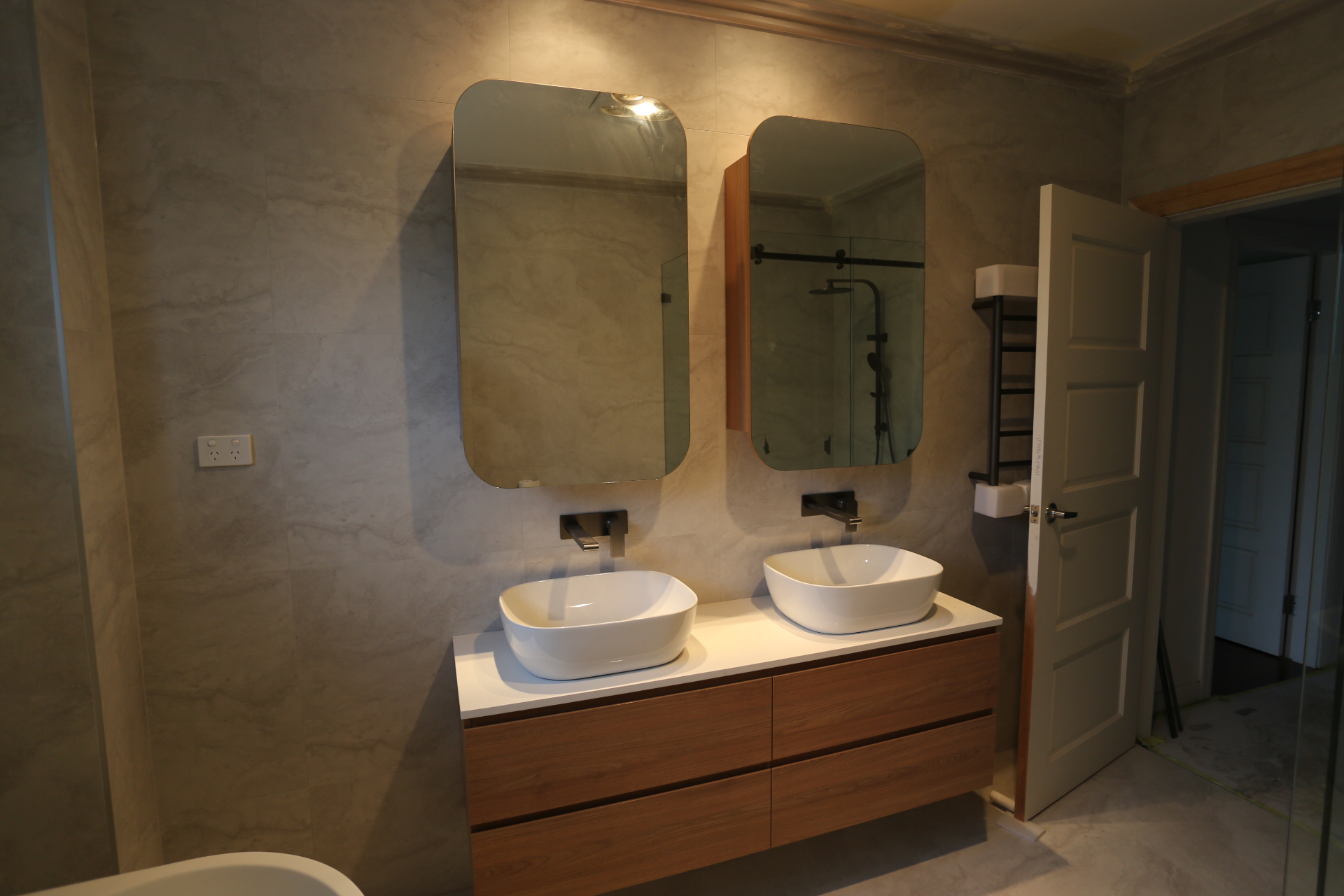 Bathroom with twin vessel basins and walnut vanity cabinetry by Mr Woodworx
