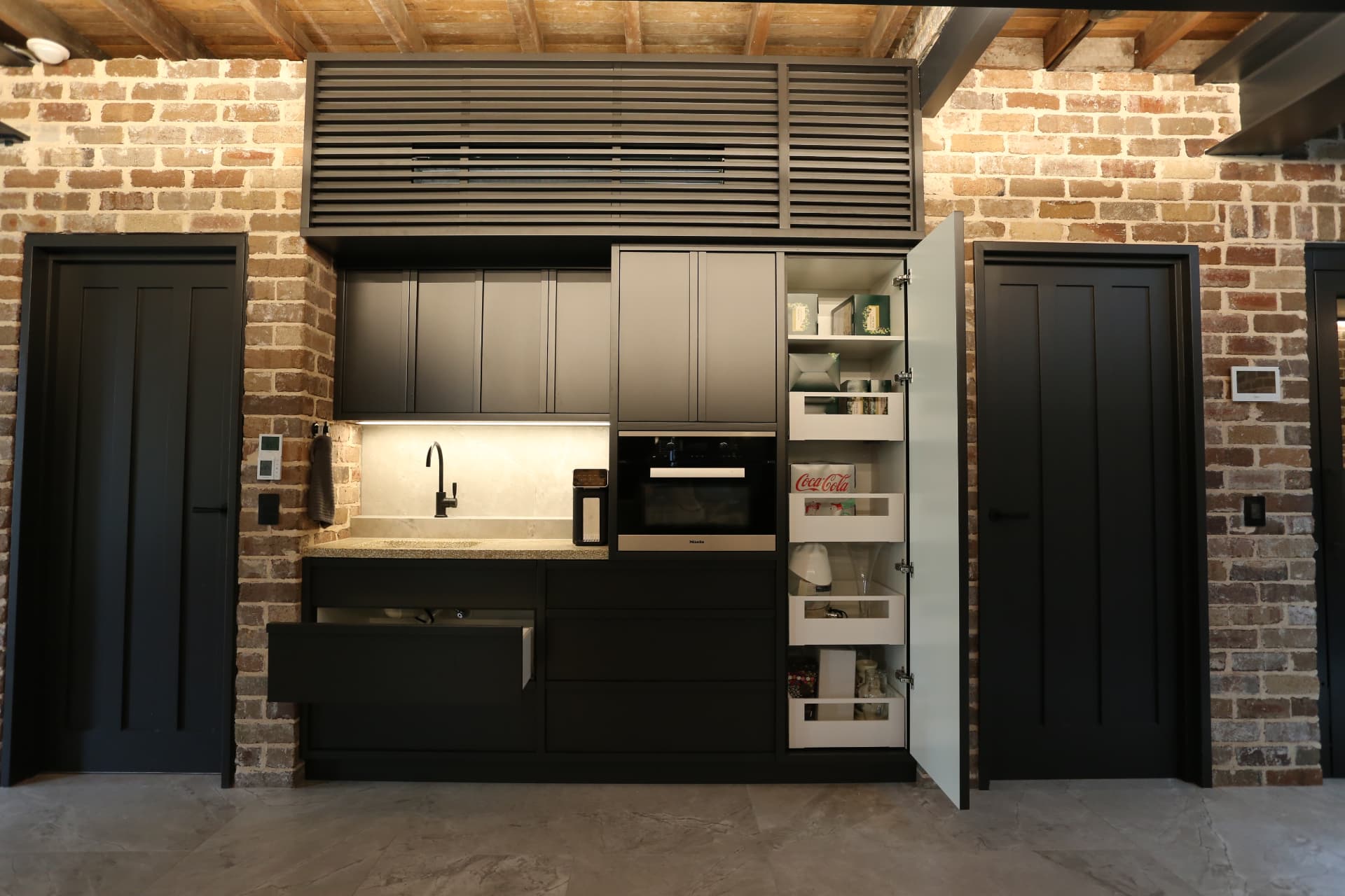 Butler's kitchen with pantry door open revealing white internal drawers and shelving in Cremorne by Mr Woodworx
