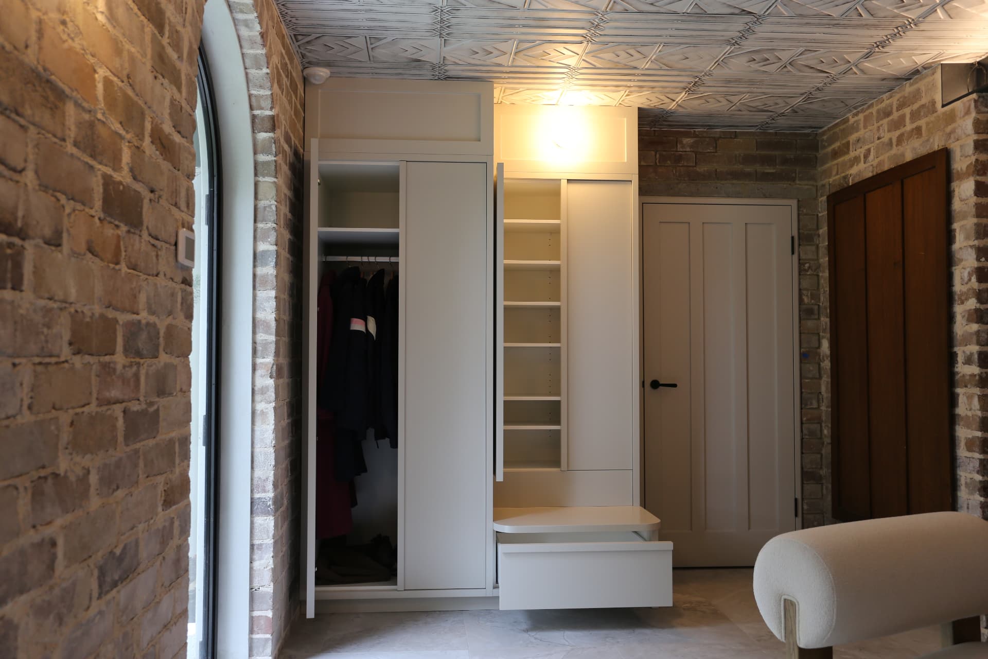 Open entry joinery showing coat hanging space, adjustable shelving and bench seat in a Cremorne home by Mr Woodworx